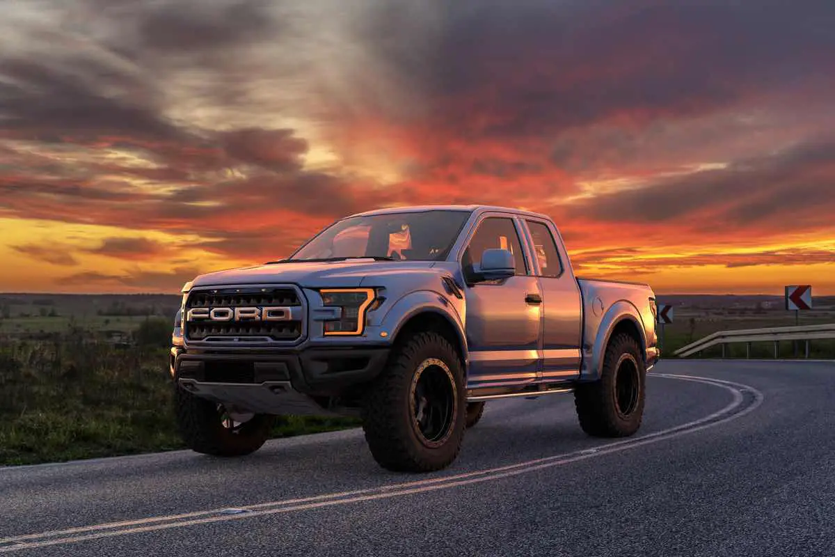 Ford F-150 Raptor - Most Extreme Production Truck On The Planet standing on the road at sunset